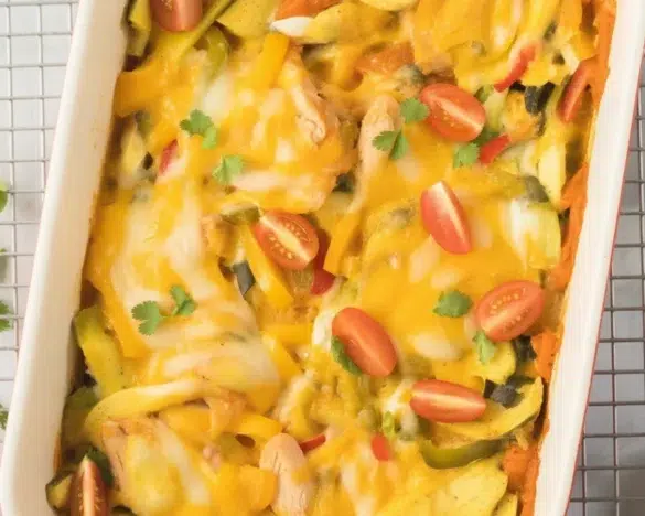 Delicious Chicken Enchilada Casserole topped with melted cheese and garnished.