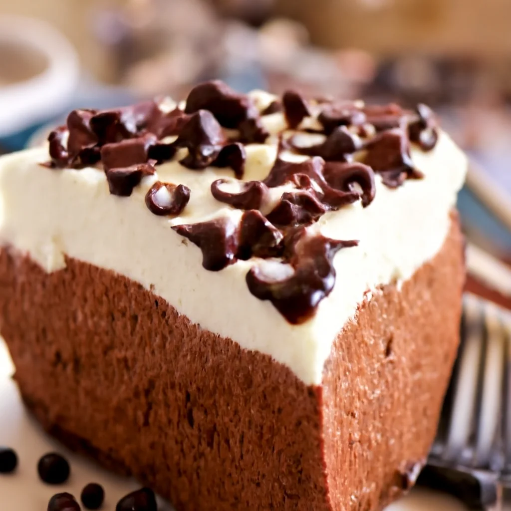 Homemade French Silk Pie with an Oreo crust and creamy chocolate filling topped with whipped cream.
