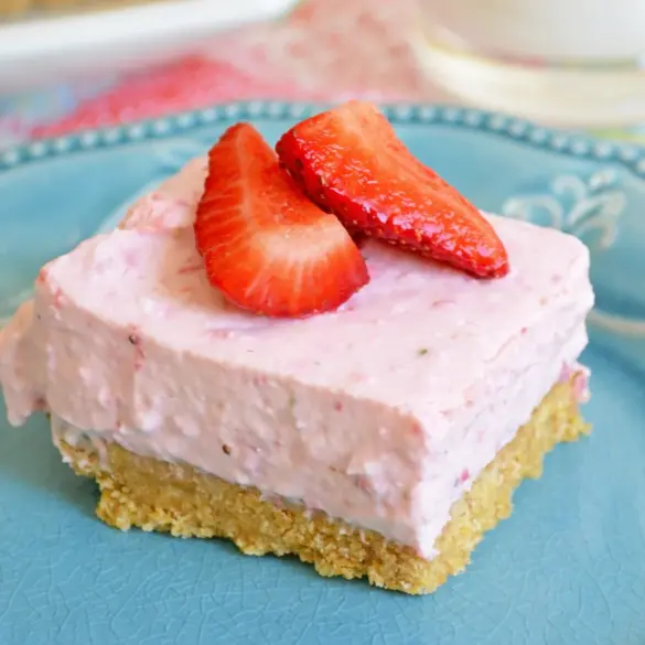 Delicious No-Bake Strawberry Cheesecake Bars with fresh strawberries and graham cracker crust.