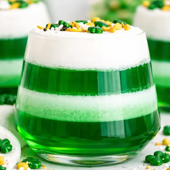 Colorful St. Patrick's Day Jello Cups layered with green jello and whipped topping.