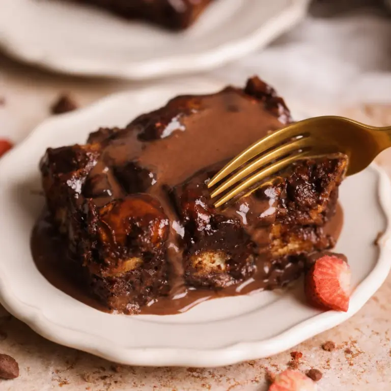 Warm Easy Bread Pudding with Chocolate served with a drizzle of chocolate sauce.