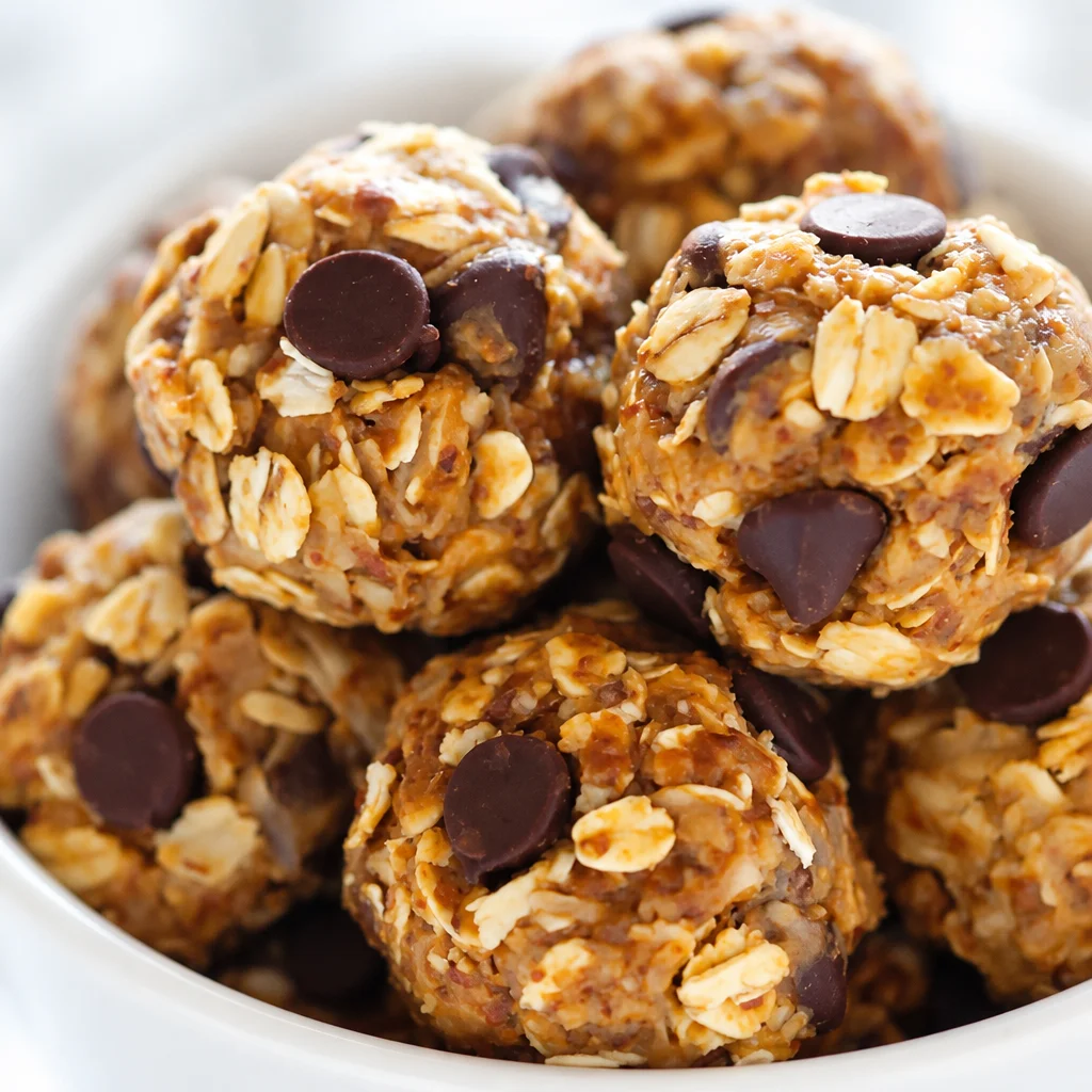 Easy Peanut Butter Energy Balls with chocolate chips arranged on a plate.