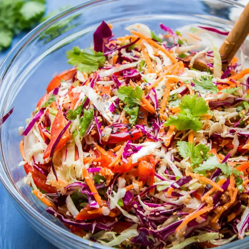Colorful Easy Asian Slaw with Sesame Ginger Dressing served in a bowl.