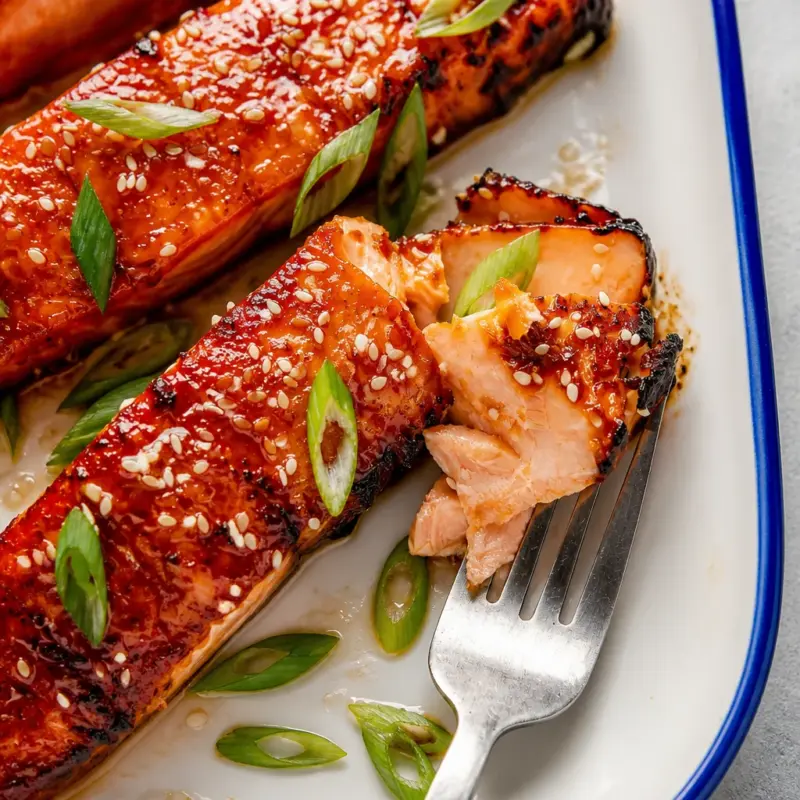 Plate of Easy Miso Glazed Salmon garnished with herbs and served with rice.