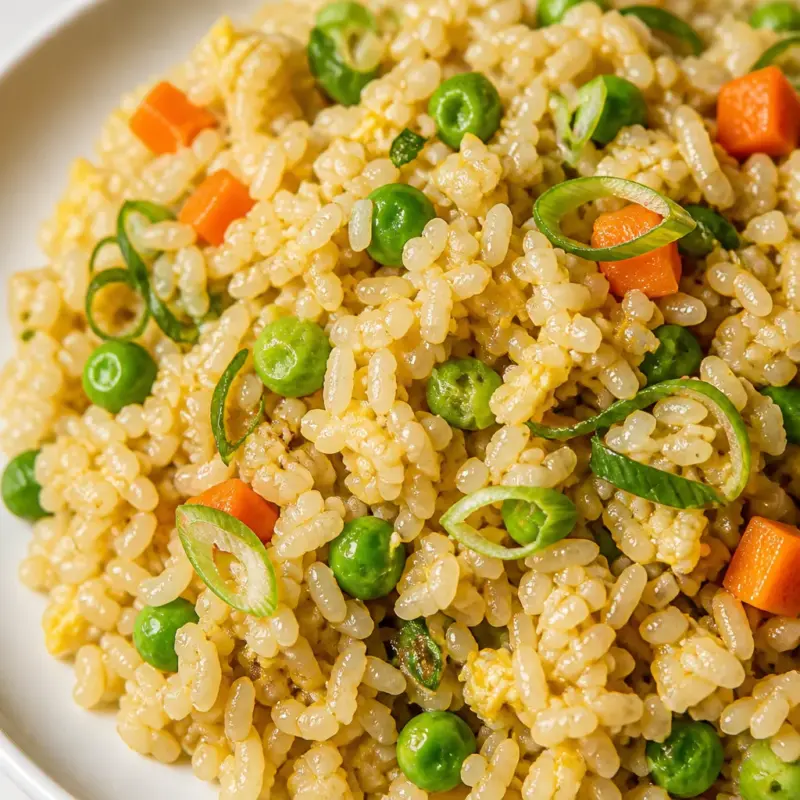 Bowl of Easy Pantry Fried Rice with colorful vegetables and scallions on top.