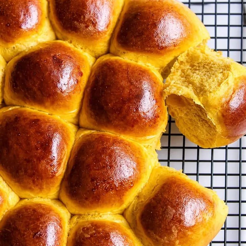 Soft and fluffy easy pumpkin dinner rolls ready to be served, perfect for fall dinners.