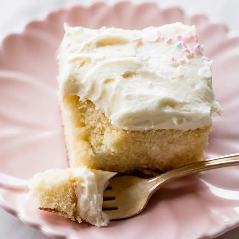 Moist and fluffy Easy Sheet Cake Vanilla topped with whipped buttercream frosting.